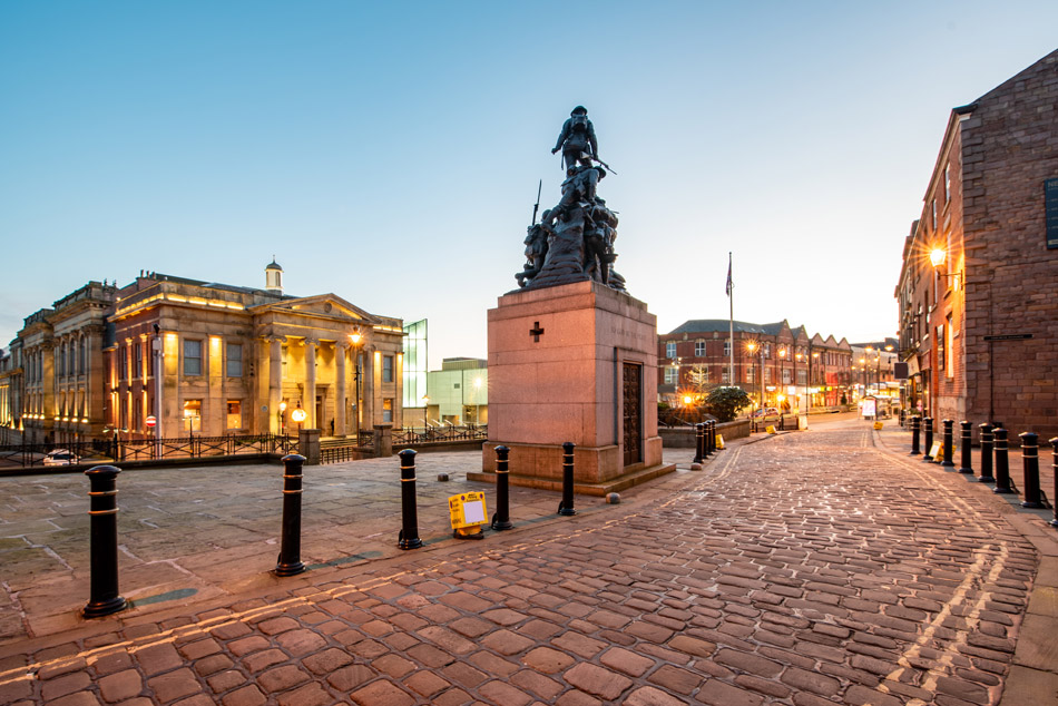 Town hall in a Yorkshire Street with War memorial Sculpture in Oldham City, UK