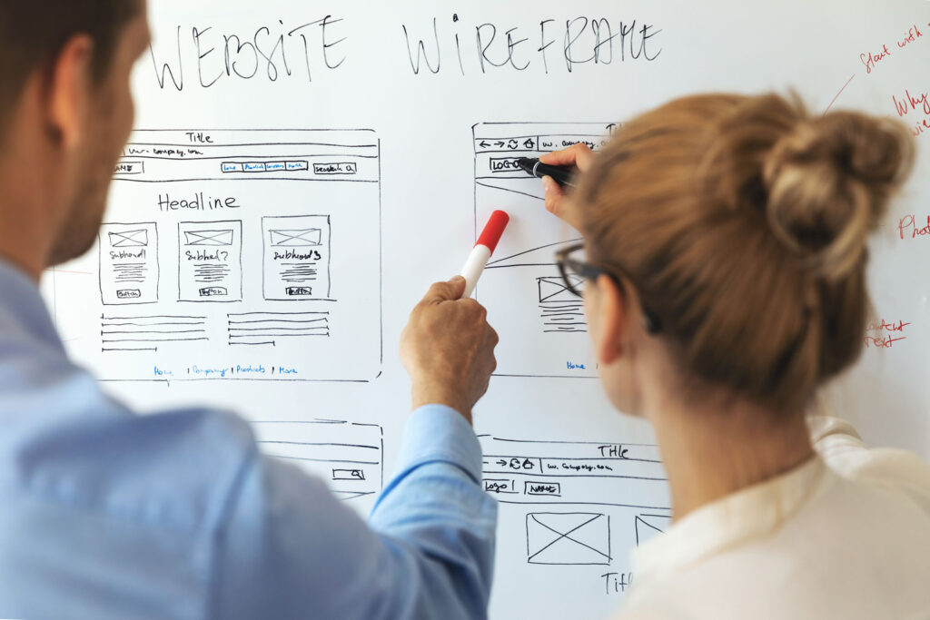 Web designers wireframing a website design